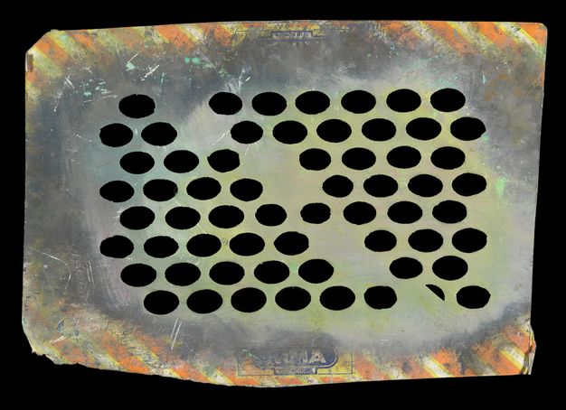 Stencil. The original yellow and orange diagonal stripes of this roughly rectangular of cardboard are largely covered with grey and muted lime-green paint. The cardboard has been perforated to create a mostly uniform grid of wide ovals, though the pattern is broken down the centre.