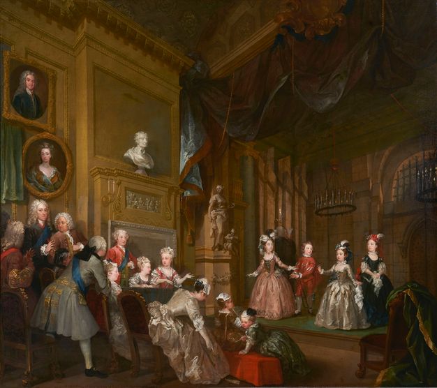 Painting. Four children stand on a shallow, low stage in a well-appointed room as about a dozen men, women, and additional children look on or talk to each other from in front of a hearth. They all have pale skin. The men wear white wigs and the women shimmering dresses. A bust and painted portraits are above the mantle.