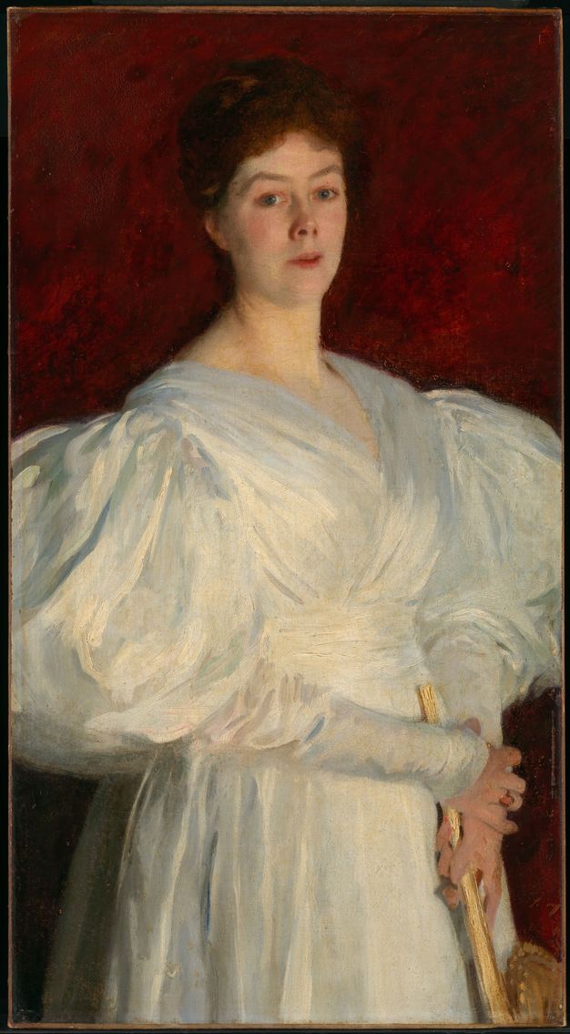 Painting. Shown from the hips up, a pale-skinned woman wearing a white gown with hugely puffed sleeves stands in front of a garnet-red background. Her shoulders angle to our right but she turns to look at us, her peaked eyebrows raised, and her lips parted. The sleeves extend off both sides of the canvas.