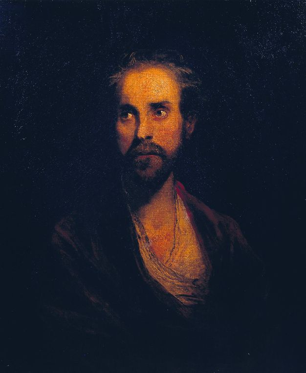 Painting. The head and shoulders of a pale-skinned man nearly fill this portrait. His body faces us, but his eyes cut to our left. He has a thin face with a straight nose, and his thin lips are set in his beard. His dark hair and clothing blends into the black background.