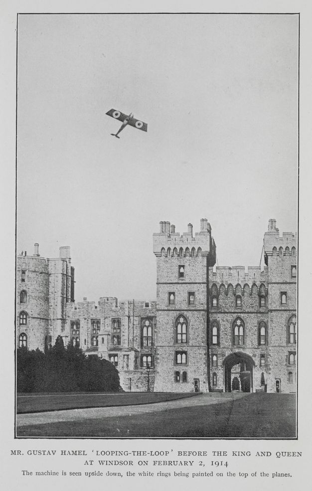 Black and white photograph. An airplane appears to fly almost straight up over a stone castle. White rings are painted on the wings. Text under the image reads, “Mr. Gustav Hamel ‘Looping-the-Loop' before the King and Queen at Windsor on February 2, 1914 The machine is seen upside down, the white rings being painted on the top of the plane”.