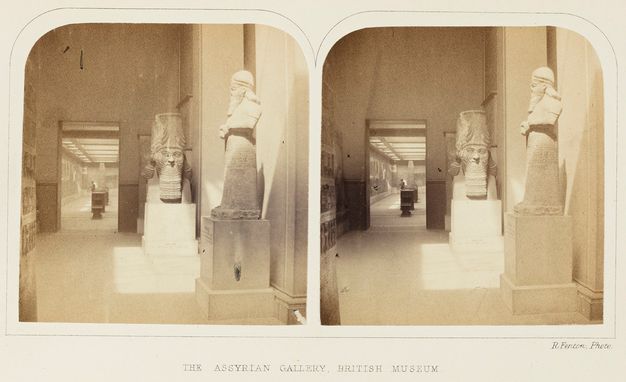 Sepia-toned photograph. Two almost identical photographs of a museum sculpture gallery are mounted on a labelled card. Each photograph is rounded at the top corners.