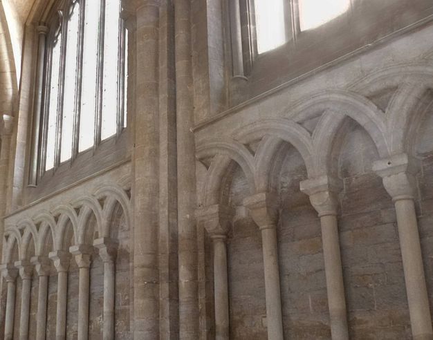 Architecture. Rows of blind stone arches overlap creating a woven effect.