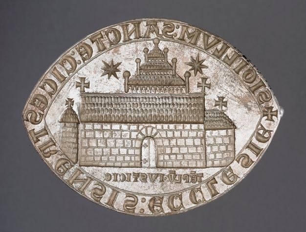 Seal. This oval seal has pointed ends, like a marquise-cut diamond. It shows a church with an attached chancel to our right and a freestanding tower to our left. A three-stepped tower structure is above the long roof of the church. Two starburst-like forms are in the sky. Words run around the perimeter of the seal.
