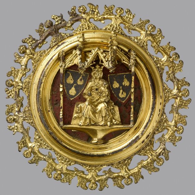 Plaque. A golden, medallion-like roundel shows an enthroned, crowned woman with a baby, the Virgin and Child, with heraldic shields to each side. The perimeter is made up of a band of angels, shown hand-in-hand from the waist up.