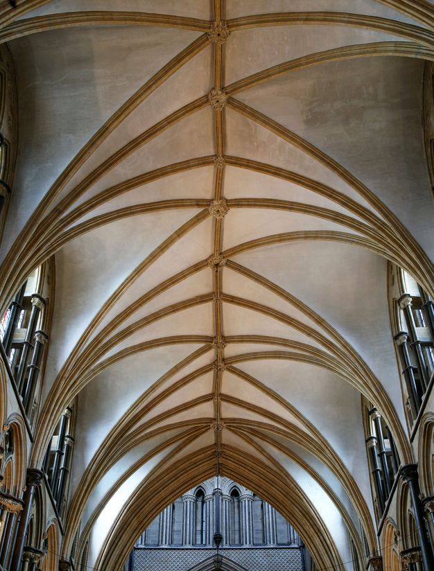 Architecture. At first glance, the gold ribs of this church ceiling seem to create a freeform zigzag across the white vault. The ribs are neither equally spaced nor symmetrically laid out, but they do form a complex pattern, which takes a few moments to puzzle out.
