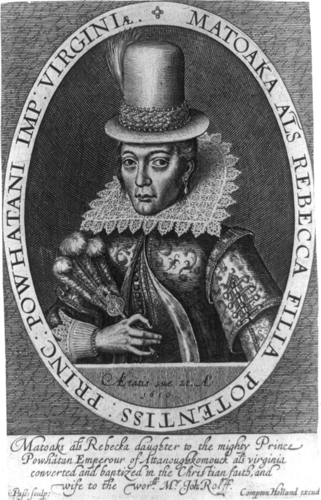 Print. A woman wearing a lavish dress, a stiff lace collar, and a tall hat with a feather is shown from the waist up in an oval frame. She holds a feather fan in one hand. Text around the oval frame reads, \“Matoaka Als Rebecca Filia Potentiss: Princ: Powhatani Imp: Virginiæ\” More text is below.