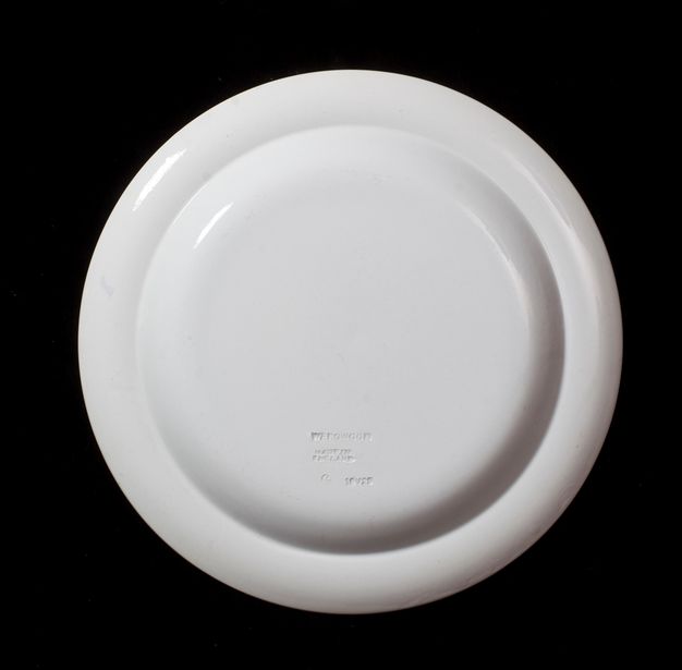 Plate. The underside of a white plate is stamped \“Wedgwood Made in England\”.