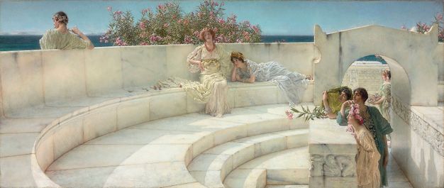 Painting. Sunlight drenches five women and two men who wear flowing robes and sit or stand around a curving white marble bench. Five of the people have pale skin and two, a man and a woman, have daker complexions. The bench creates a C shape facing our right. A bank of pink blossoms peeks over the back of the bench around a woman sitting near the centre of the composition. A strip of deep blue suggests water under a clear sky.