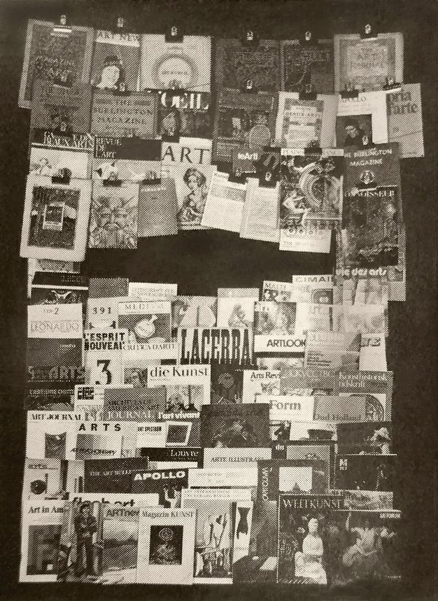 Illustration. Black and white photograph of about seventy journal covers, some clipped to wires across the top and others stacked below. Titles are in English, German, and French, among others.