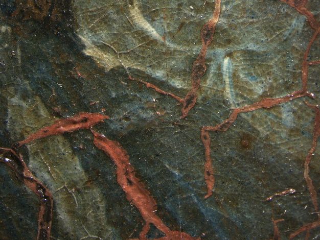 Painting. Detail view of coral-red paint showing through cracks in a layer of muted and light blue.
