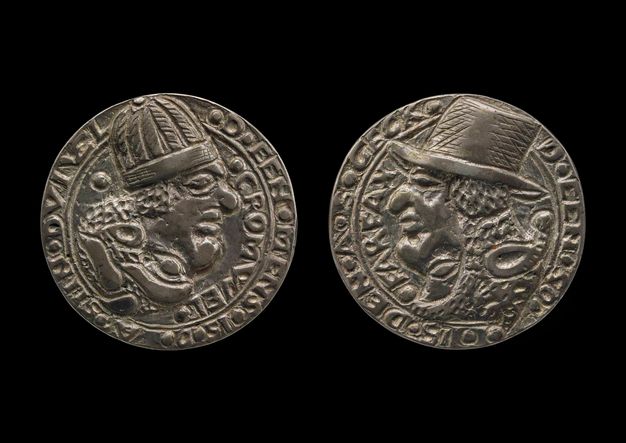 Medal. Both sides show profile portraits of men, both with exaggerated, bulbous features. The man on the recto, to our left, wears a rounded cap. The other, to our right, a brimmed hat. Text is around the perimeter of each.
