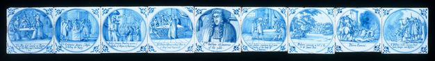 Tiles. Nine tiles painted blue against white show groups of people or, for the one in the centre, a portrait of a single person. Details in the pictures and writing under each are difficult to make out in this image.