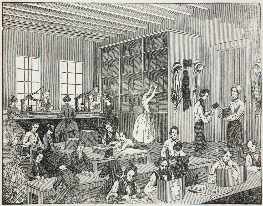 Print. Twenty-three men and women with pale skin work at benches or fetch materials or products in a high-ceilinged workroom in this engraving. The women wear a dress and most men wear a white shirt, neck tie, and vest. 