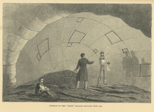 Print. Two men stand and one sit inside a half-inflated balloon. The shadowy silhouettes of people waiting outside are cast on the side of the balloon to our right.