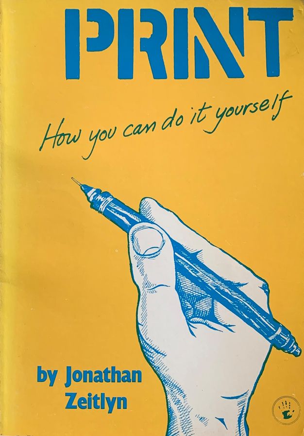 Cover of the book titled "PRINT: How you can do it yourself" by Jonathan Zeitlyn. The cover features a yellow background with the word "PRINT" in large blue letters at the top. Below, the subtitle is written in a casual script style. The central illustration depicts a hand holding a pen, drawn in blue, with detailed line work. The author's name is placed at the bottom in blue text. A small emblem of a smiling sun is present in the lower right corner.